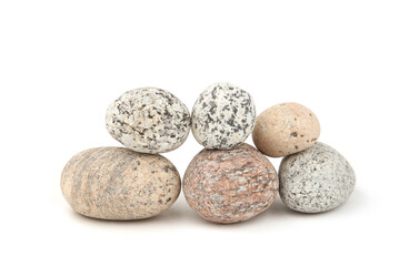 Naklejka na ściany i meble Sea smooth oval pebbles isolated on white background. Heap of stacked round pebbles.