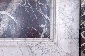 A close up shot of a corner of a window made up of marble along with some irregular lines drawn in black over it