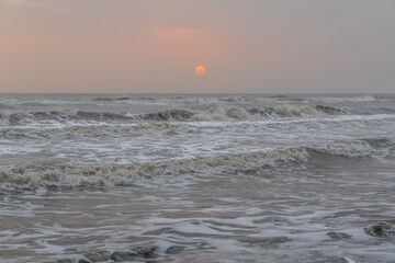 Gloomy sunrise at stormy sea landscape