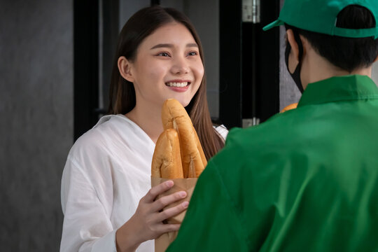 Happy woman recieving food from food deliveryman