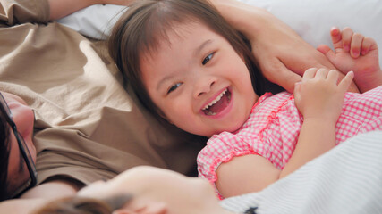 Happy family with mother, father and disabled daughter spending time together at home..