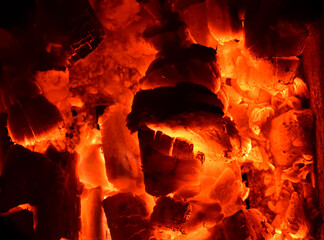 Hot wood burns out in the village stove