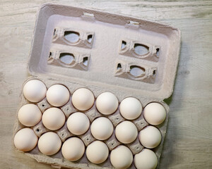18 eggs in an open carton.