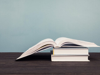 Open book on blue background, open pages as a concept of new knowledge, online self-study