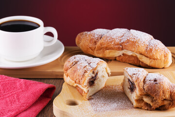 crispy freshly baked buns with chocolate cream and hot black coffee is very tasty
