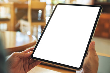 Mockup image of a woman holding digital tablet with blank white desktop screen