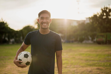 Male soccer football player. man soccer player smiling in field.
