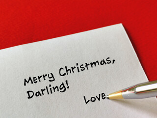 One person is writing a christmas greeting card.