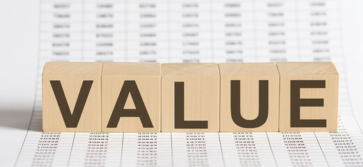 wooden cubes with letters VALUE on chart background