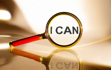 I CAN concept. Magnifier glass with text on white background in sunlight.