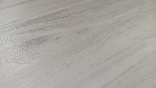 Light grey laminate texture, close-up. Beautiful textured wood floor.
