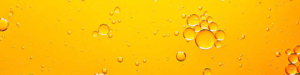 oil with bubbles on coral background. Orange Abstract space background. Soft selective focus. macro of oil drops on water surface. copy space. air bubbles in water, Banner format