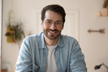 Close up headshot screen view of smiling Caucasian man in glasses have webcam conversation online....