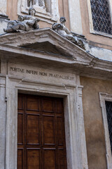 church entrance with statues, San Pietro in Monastero church door with statues at Verona city
