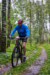 Obraz premium Men is riding on bicycle.