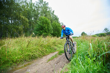 Fototapeta premium Men is riding on bicycle.