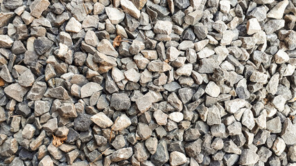 Granite gravel road texture. Natural crushed stone background. Grey  copy space surface with...