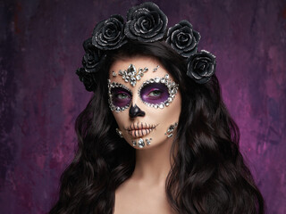 Portrait of a woman with sugar skull makeup over red background. Halloween costume and make-up....