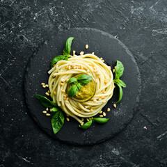 Pasta with pesto sauce, basil and pine nuts. Italian food. Top view.