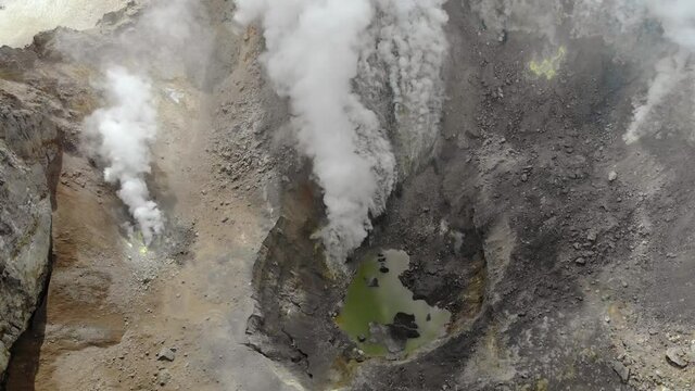 Mutnovsky volcano crater with lake in the center in Kamchatka, Russia