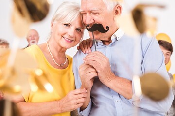An elegant senior couple having fun on New Year's Eve party