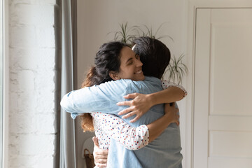 Smiling millennial Caucasian couple embrace show love and care, feel grateful thankful in family...