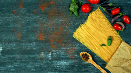 Ingredients for cooking spaghetti on a dark background . There is space for text