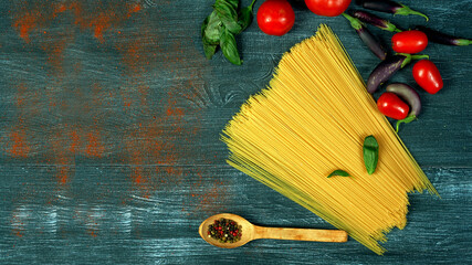 Ingredients for cooking spaghetti on a dark background . There is space for text