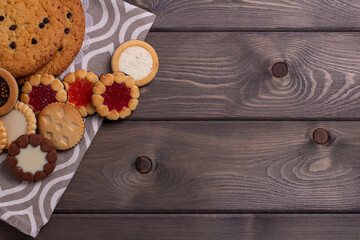 shortbread cookies with various sweet fillings on the wooden rustic table