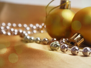 Golden Christmas background, New Year's decor. Christmas balls in smowdrifts and golden bokeh lights