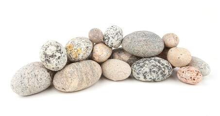 Sea smooth oval pebbles isolated on white background. Heap of stacked round pebbles.