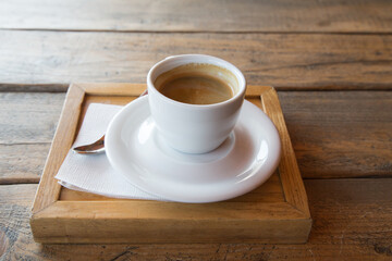 Cup of coffee on a wooden table.