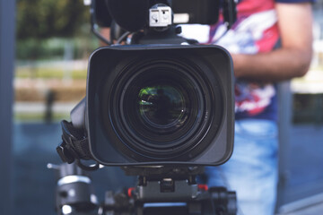 Camera lens for broadcast is focused on program guests