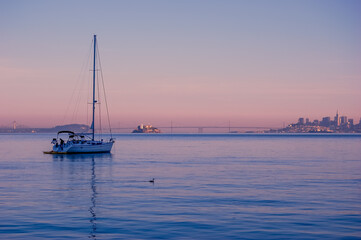 A boat and San Francisco skyline at sunset