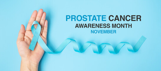 November Prostate Cancer Awareness month, Man holding light Blue Ribbon for supporting people...