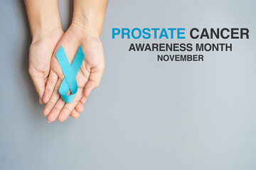 November Prostate Cancer Awareness month, Man holding light Blue Ribbon for supporting people...