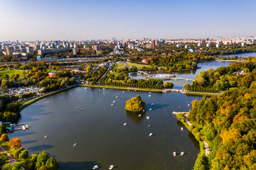 a panoramic view of the historic lake and park complex with roads and bridges filmed from a drone