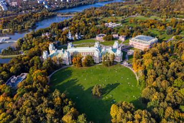 a panoramic view of the ancient palace and a large green park complex with a lake filmed from a drone