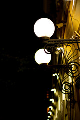 A beautiful street lamp shines in the night.