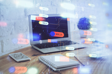 Double exposure of laptop computer and technology theme hologram. Concept of freelance work.