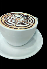 A Cup of Coffee With Latte Art on Top of it with Black Background.