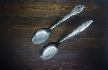Empty spoon on the wooden background. Kitchen equipment. Food symbol retro design. 