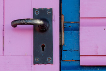 old pink door with close up of door handle