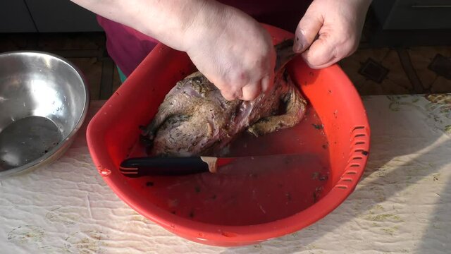 the chef peels and cuts the goose into pieces.  healthy food concept