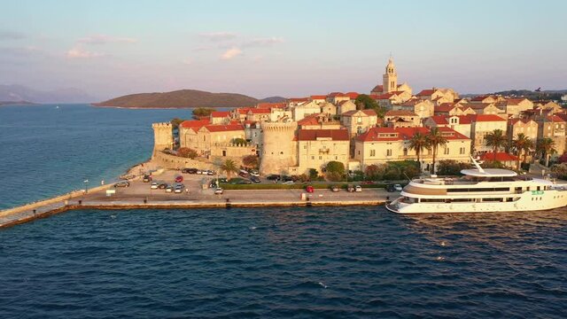 Aerial view of the Korcula old town in Croatia by the Adriatic sea in the Balkans, shot with a slide or traveling motion