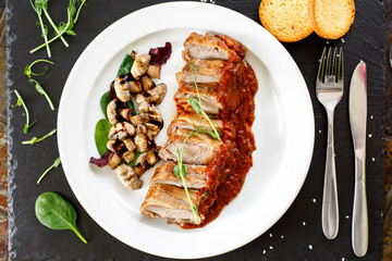 Veal medallions with bacon and mushrooms under adjika