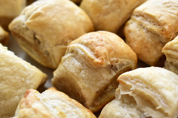 Sausage roll savoury pastry snack on a white plate.