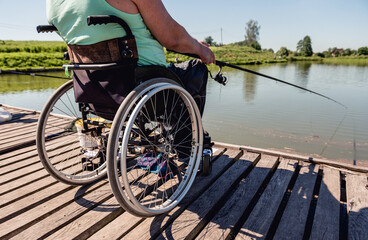 Young disabled man in a wheelchair fishing.