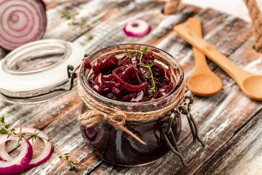 Homemade onion marmalade jam, confiture, chutney on a rustic wooden table. Delicious sauce. French cuisine