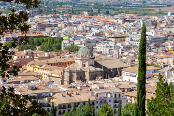Fototapeta na wymiar View of the Realejo district of Granada from the Carmen de Los Martires, with the church of Santo Domingo and the white houses around
